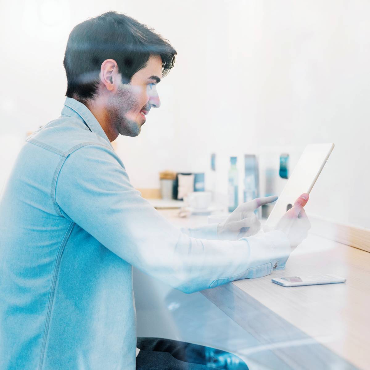 smiling_man-using_tablet